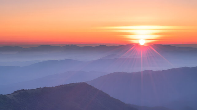 Sunrise over misty mountain layers with radiant sunburst and vibrant sky