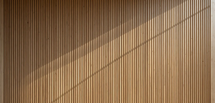 Brown wooden slatted wall with diagonal shadow, warm lighting slats