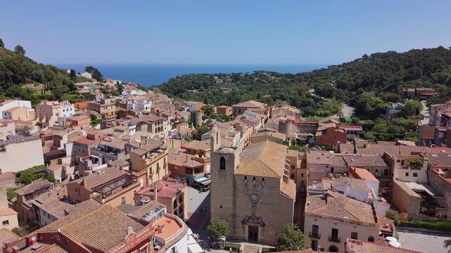 High angle aerial view of Sant Pere church and old town streets in Begur.