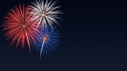 Fototapeta premium Red, white, and blue fireworks light up the night sky, patriotic celebration, New Years Eve or Independence Day. Shallow depth of field.