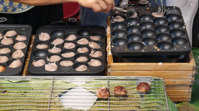 Making Khanom Babin (Thai coconut cakes or pancakes), traditional dessert, street food, Thailand. It is believed that the dessert was originated from Ayutthaya period. 