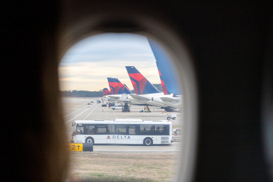 Delta Air Lines aircraft and ground service bus seen through airplane window at Hartsfield-Jackson Atlanta International Airport on January 21, 2026 in Atlanta, Georgia, USA.
