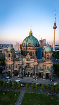 Berlin Cathedral (Berliner Dom) vertical drone view with Berlin TV Tower on the background, during sunset. Berlin, Germany.