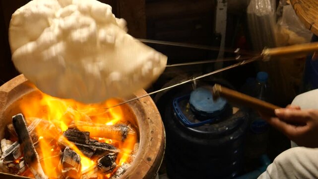 Grilling traditional Thai rice cracker