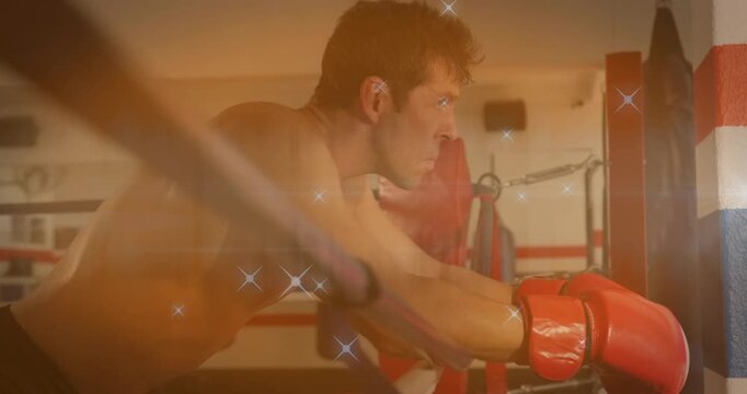 Breathing during rest, boxer leaning on ring ropes, raising head, refocusing under sparkle overlay