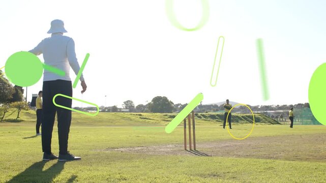 Cricket umpire watching as bowler running bowling for runs, green shapes overlapping players stumps
