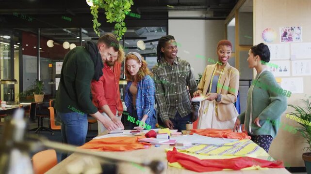 Design team following left man pointing swatch at table with tags marking fabrics seeking consensus