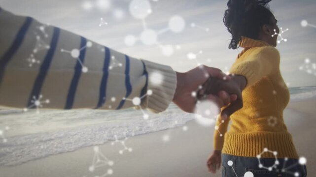 Woman reaching back and pulling partner exploring shore, molecule overlay drifting for travel ads