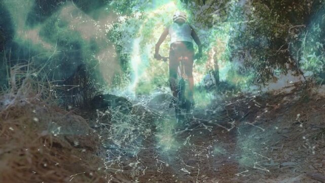 Woman cyclist riding uphill on dirt trail, pedaling and starting nebula glow rising for sports