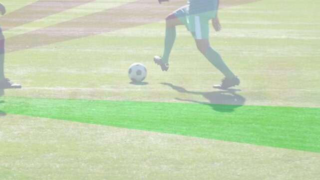 Lead player touching soccer ball drawing teammates into passing drill on pitch with coach watching