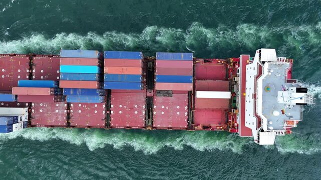 Cargo container Ship, cargo maritime ship with contrail in the ocean ship carrying container and running for export concept technology freight shipping sea freight by Express Ship. top view
