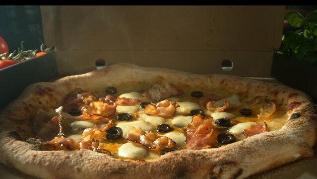 Appetizing piece of pizza lying in an opening paper box