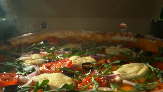 Appetizing piece of pizza lying in an opening paper box