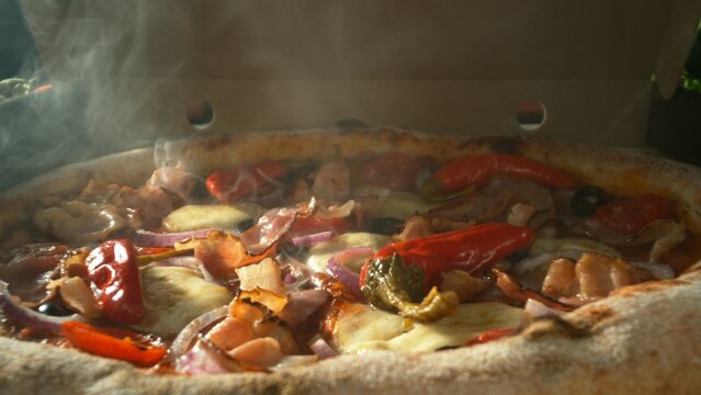 Appetizing piece of pizza lying in an opening paper box