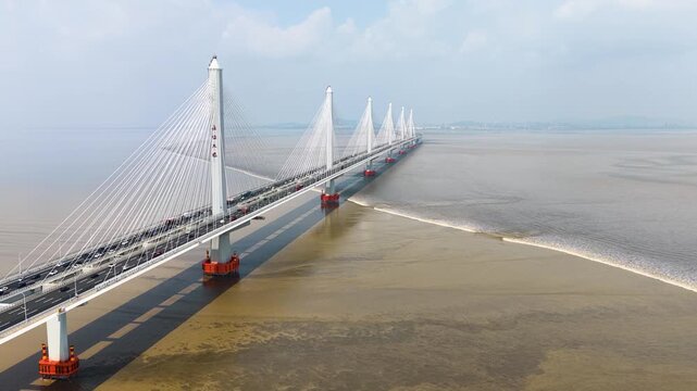 Shaoxin, China - 04. April 2026: The rising tide is coming to the Jia-Shao Bridge over the Hangzhou bay. The bridge is the most important connection over the bay.