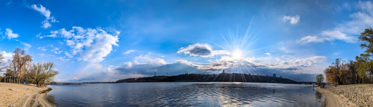 Spring aerial panoramic view on sand beach river. Blue beautiful cloud sky reflected clear water. Calm contemplation nature. Light smooth atmospheric sunbathing and swimming. Sunset with clouds