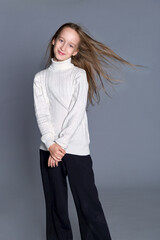 Fototapeta premium A moment of serene introspection for a girl in a snug sweater. childhood and simplicity.