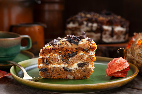 Slice of Homemade Pumpkin Cake Torte with walnuts, prunes and creme.