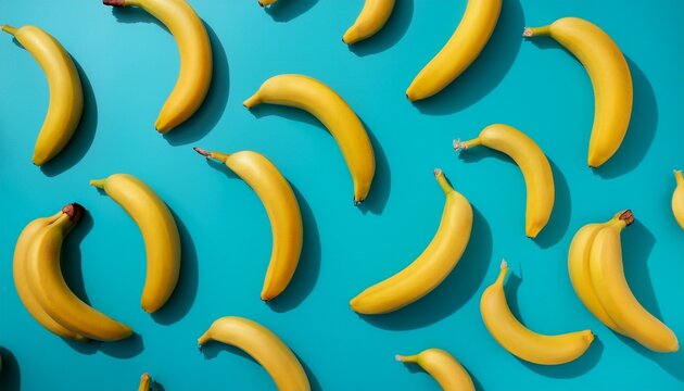pattern made of yellow bananas against a cyan blue background minimal nature fruit food concept healthy diet wallpaper