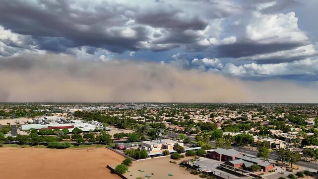 Fast panning aerial view of large dust storm haboob over Arizona desert