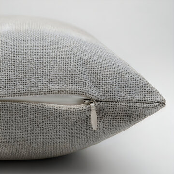 Close up of soft grey textured linen throw pillow with zipper detail isolated on plain white background for home decor