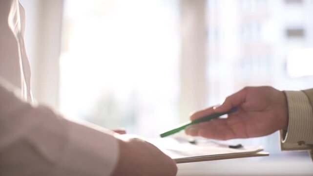 A close-up of a business handshake between two unrecognizable people