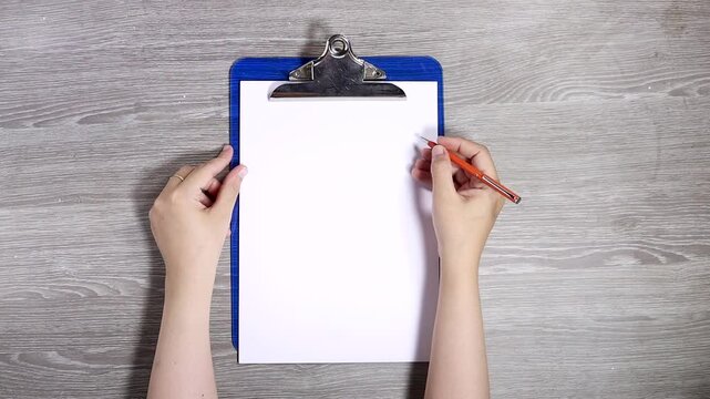 hands woman writing on clipboard