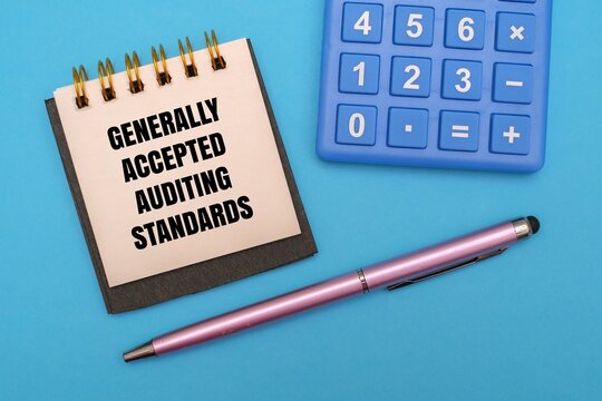 Generally Accepted Auditing Standards - GAAS text on notepad next to calculator, and pen on a coloured background. Symbolizing professional financial compliance and accounting