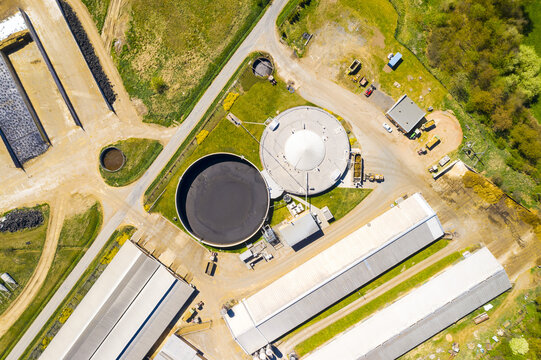 Biogas plant and farm in fields. Renewable energy from biomass. Aerial view to Czech industry. Sustainable development in European Union.	
