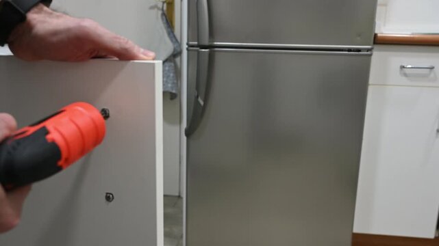 Using screwdriver to assemble furniture details