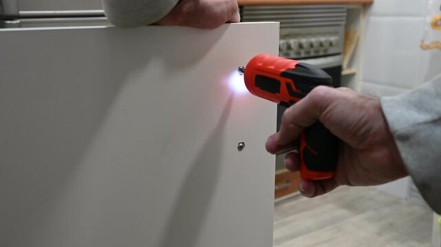 Using screwdriver to assemble furniture details