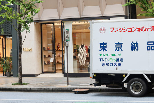 TOKYO, JAPAN - September 9, 2021: A fashion delivery truck parked by a Chloe store on a main street in Tokyo's Ginza area. The vehicle runs on natural gas.