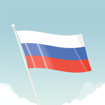 Russian flag waving in the wind against a clear sky with clouds