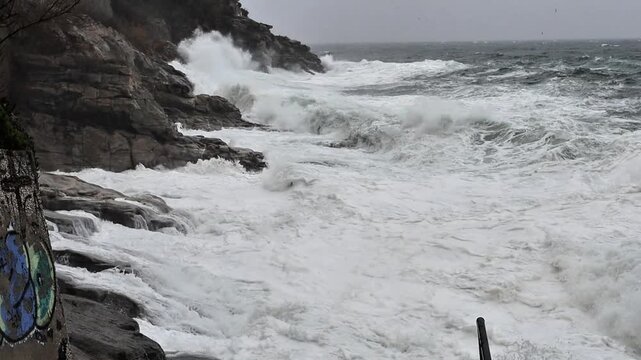 Stormy Harbor View in Kavala Greece Waves Crashing on Rocks