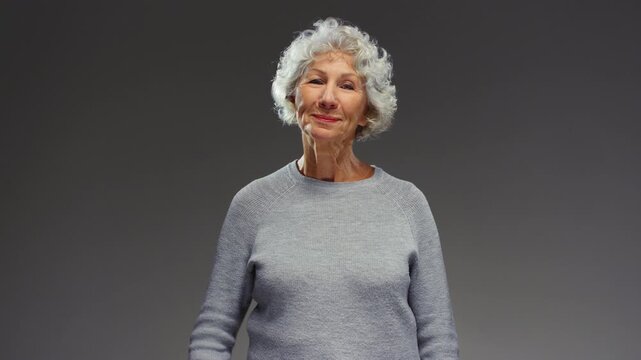 Senior woman eating white pill or drug. Elderly female takes medication. Retired Caucasian lady with grey hair gets antibiotic or painkiller, aspirin. Healthy old age, care of body. Everyday dose