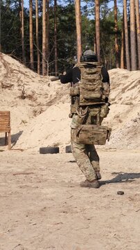 Close up of soldier in tactical equipment performing mission at range
