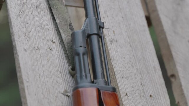 Customized AK rifle on wooden surface