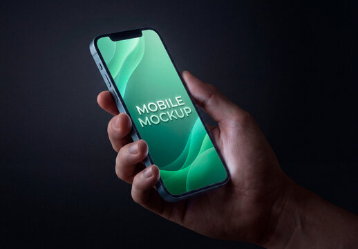 Hand holding smartphone blank screen dark background mockup