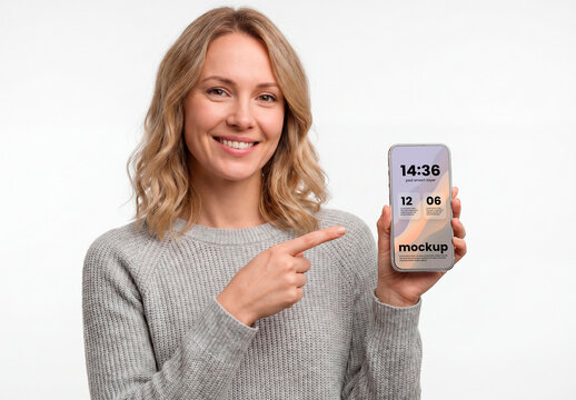 Smiling woman pointing smartphone blank screen mockup