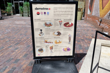Fototapeta premium a-frame with dessert menu options outside Demetres Desserts Distillery District located at 28 Gristmill Lane (Distillery District Shops & Galleries), Toronto