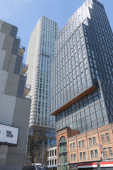 Naklejka premium looking up at a common sight in Toronto: facadectomy historic buildings integrated to condominium complex: Richard Bigley Building is called Queen Central (90-104 Queen St E)