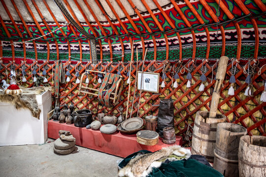 Nomadic yurts against a backdrop of mountains and valleys in Kyrgyzstan.