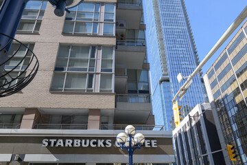 Naklejka premium sign on the exterior of Starbucks Coffee Company located at 1250 Bay St, 80 Cumberland, The Maxus, Yorkville, Toronto