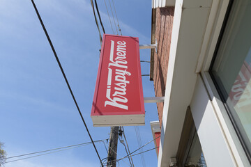 Fototapeta premium wall mounted projecting sign of Krispy Kreme Café a donut shop chain located at 284 Dupont St, Toronto