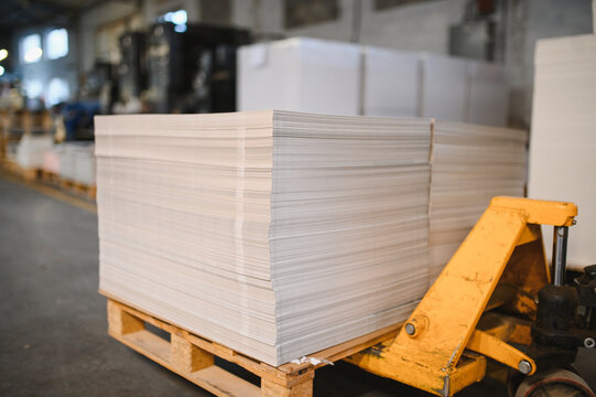 White paper stacks on pallet jack in warehouse