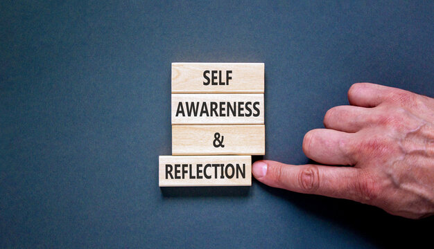 Self awareness and reflection symbol. Concept words Self awareness and reflection on beautiful wooden blocks. Beautiful grey background. Psychological self awareness reflection concept. Copy space.