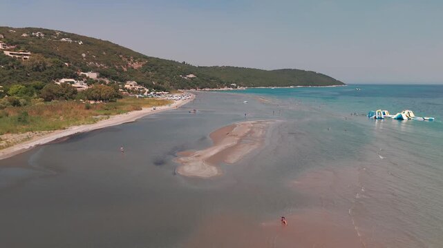 Low Aerial Drone Flight Above Sandy Beach Shoreline at Paralia Kalamaki Corfu Greece
