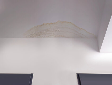 Close-up roof leak and water seepage stain on wall and ceiling. Damp damage marks, moisture spots and peeling surface in horizontal photo composition. Roof leak and seepage through wall.