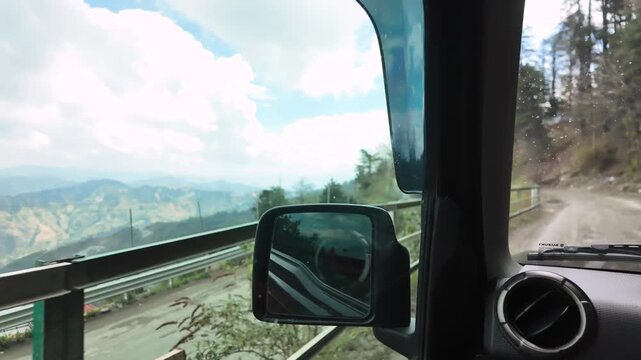 A picturesque mountain range viewed from a moving car.
