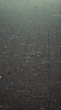 particularity. Aerial view of identical residential buildings stretching to the horizon under hazy skies. real-estate listings.
